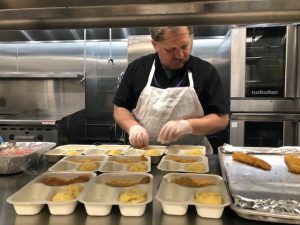 Chef preparing food in bakery: The Y Continues to Provide Essential Services Amid City Shutdown at YM&JÁ