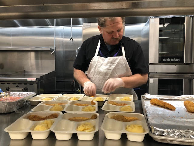 Chef preparing food in bakery: The Y Continues to Provide Essential Services Amid City Shutdown at YM&YA