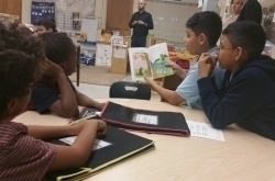 kids reading book while teacher teaching in class room at YM&YWHA