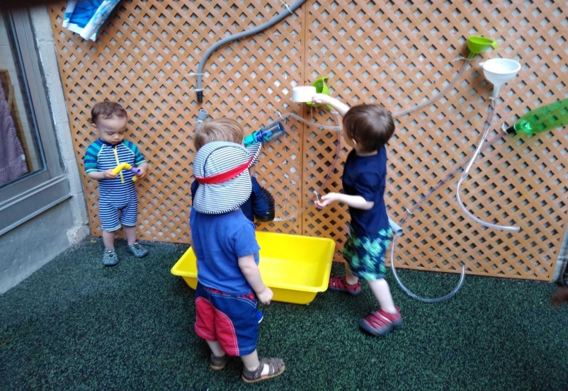 kids playing with decorative water wall at YM&YA