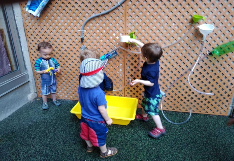 kids playing with decorative water wall at YM&TO JO